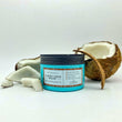 Cargar imagen en el visor de la galería, Mascarilla de coco A MUST COCO MASK nutritiva y reparadora rodeada de trozos de coco partidos y medio coco con las cascara