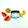 Cargar imagen en el visor de la galería, Mascarilla reestructurante THE GLAM MASK en el suelo rodeada de dos gajos de limon, dos gajos de pomelo y medio kiwi
