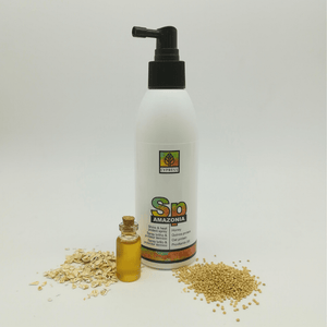 Protector termico con tapon en forma de spray rodeado de quinoa y avena esparcidos a su alrededor y un bote de cristal pequeño lleno de aceite de oliva